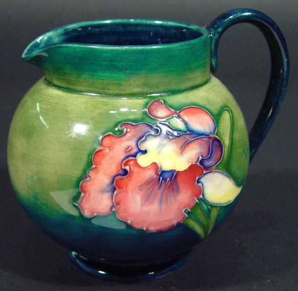 Appraisal: Moorcroft jug hand painted and tubelined with orchids onto a