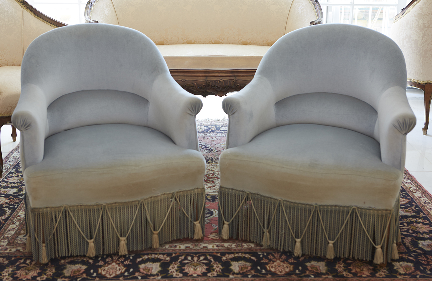 Appraisal: A PAIR OF FRINGE UPHOLSTERED TUB CHAIRS CIRCA Upholstered in