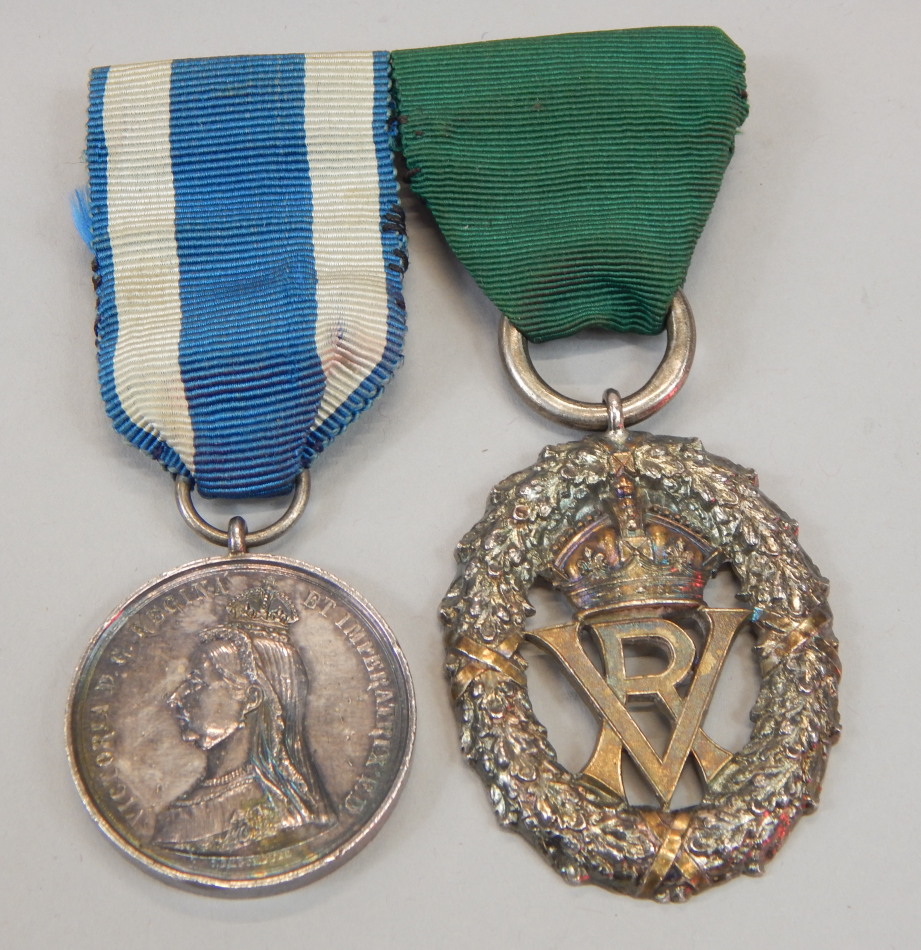 Appraisal: Two medals A silver Victoria Volunteer medal with green ribbon