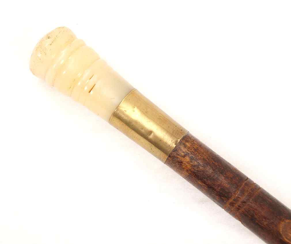 Appraisal: FOLK ART WALKING STICK CANE Plastic handle brass collar carved