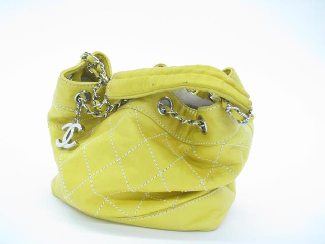 Appraisal: Chanel yellow leather drawstring purse Purse features classic quilt pattern