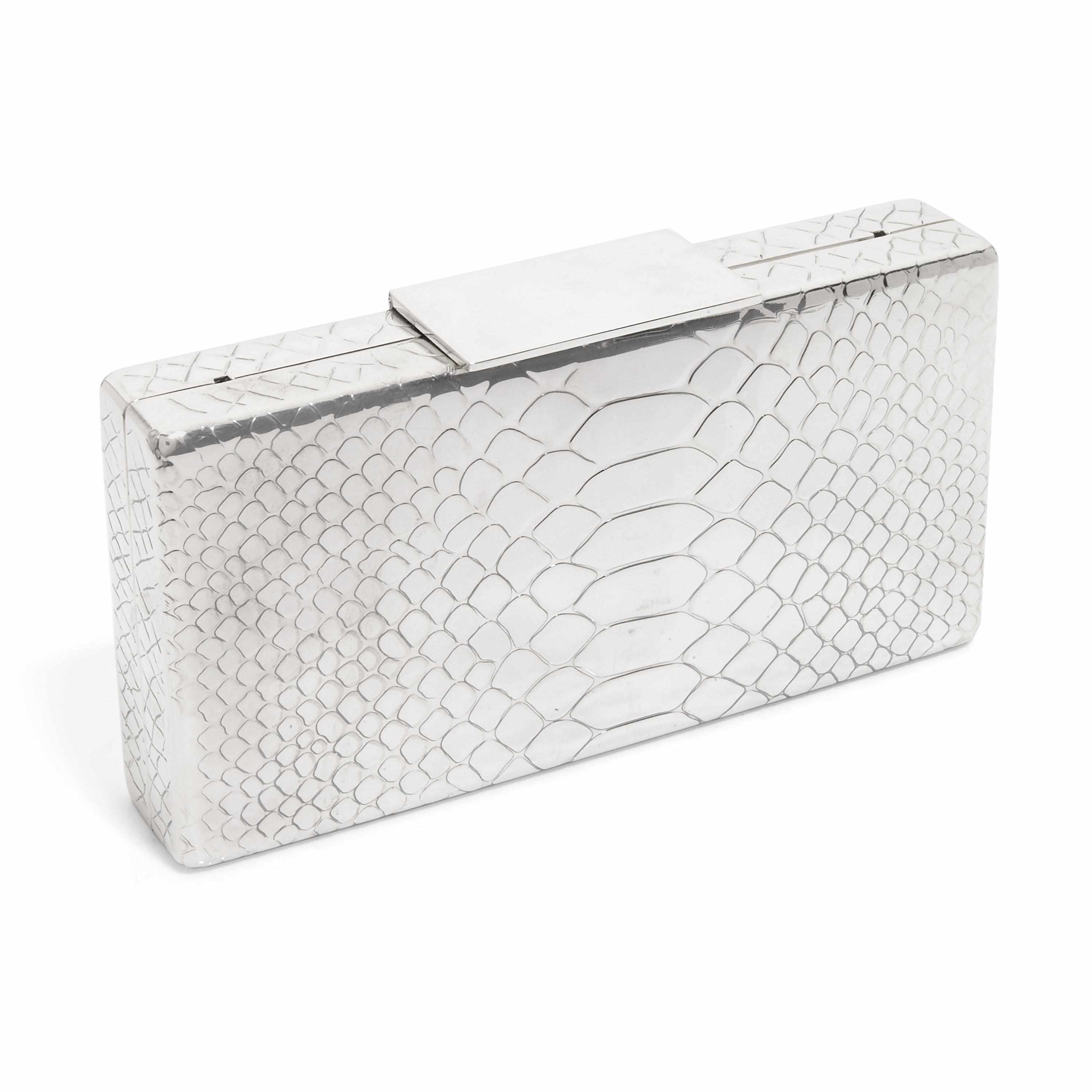 Appraisal: A rectangular-shaped silver metal embossed purse interior with a mirror