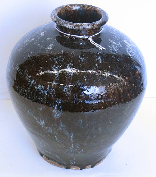 Appraisal: A black and white glazed stoneware vase With a flared