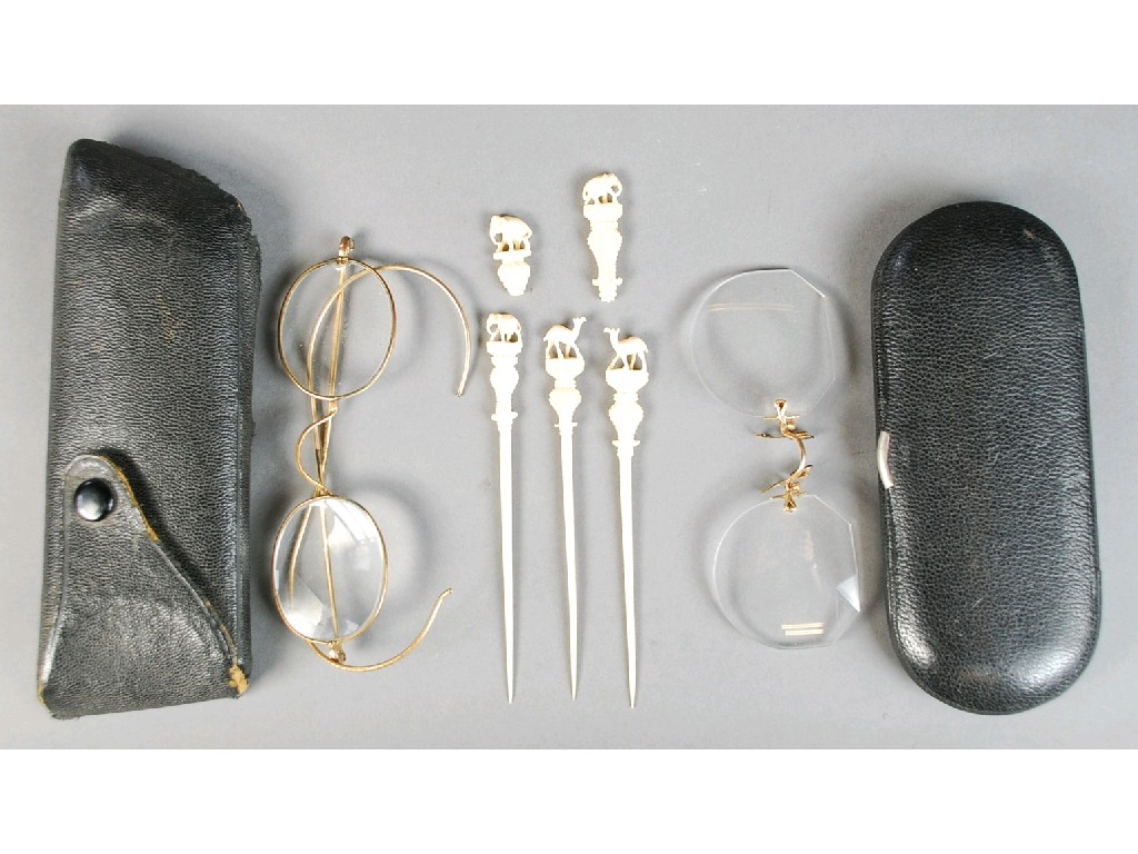 Appraisal: THREE CARVED IVORY COCKTAIL STICKS with elephant etc tops and