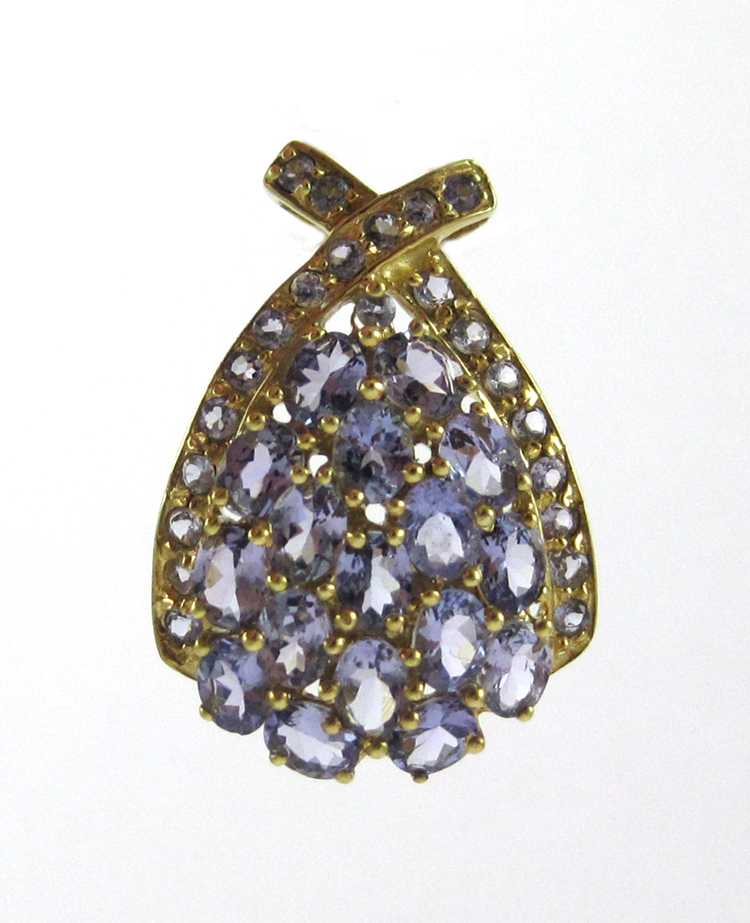 Appraisal: TANZANITE AND TEN KARAT GOLD PENDANT set with oval-cut and