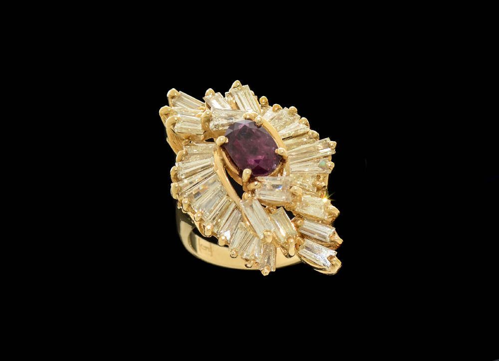 Appraisal: SOLITAIRE RUBY AND DIAMOND BAGUETTES RING An oval ruby of