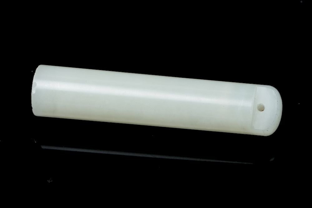 Appraisal: WHITE JADE HAT FINIAL Of a straight tubular form partially