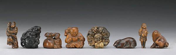 Appraisal: A group of eight wood netsuke Some th Century Comprising