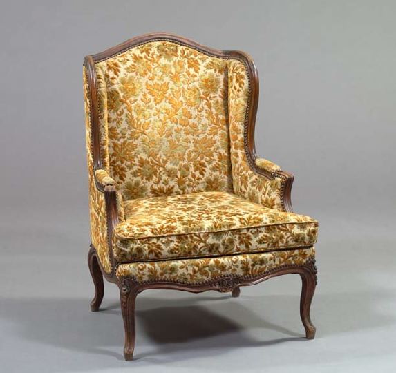 Appraisal: Louis XV-Style Fruitwood Bergere avec Oreilles late th century the