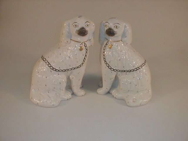 Appraisal: A pair of late thC Staffordshire pottery seated spaniels each