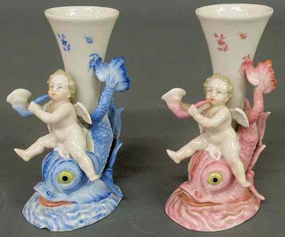 Appraisal: Pair of German porcelain cherubs riding dolphins th c h