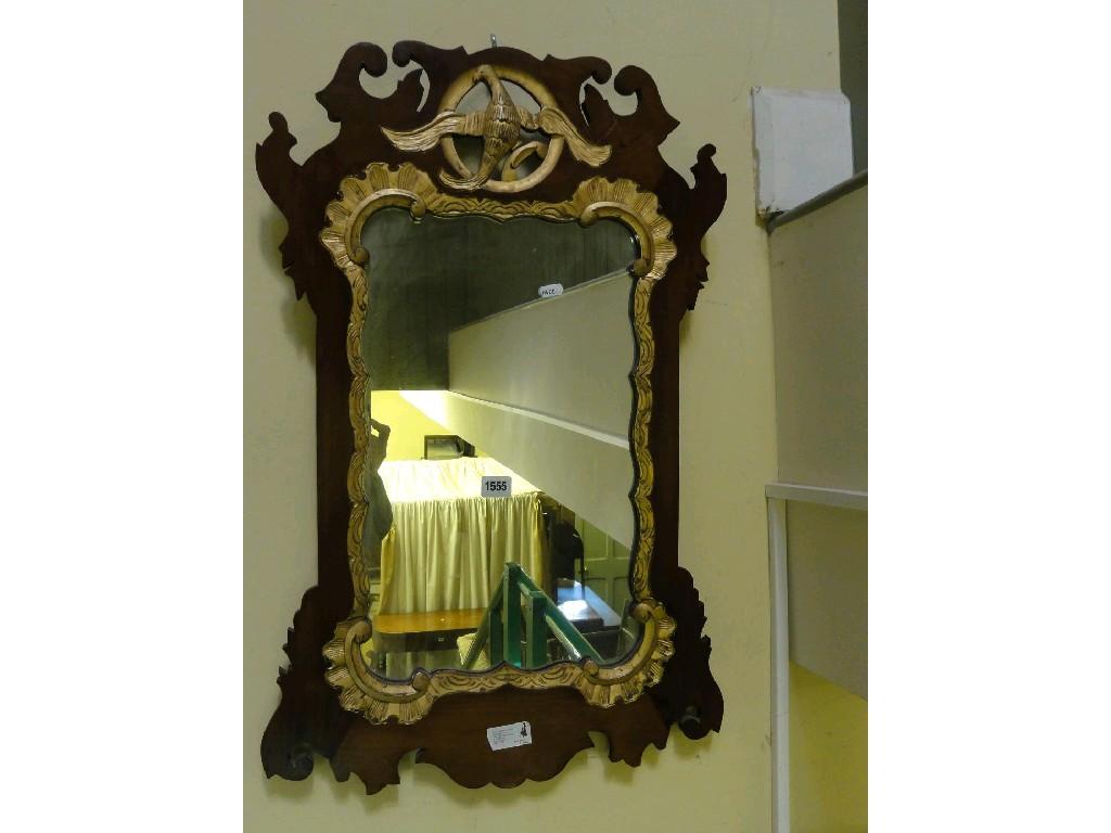 Appraisal: A Georgian style mahogany wall mirror with carved fretwork outline