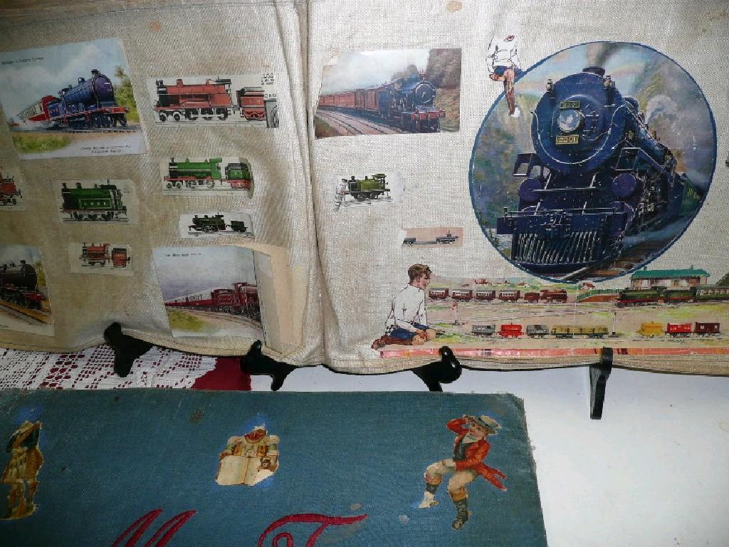 Appraisal: Vintage fabric scrapbook various scraps and pictures including trains animals