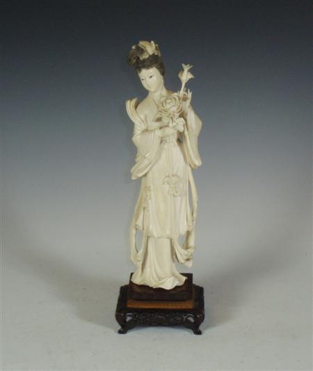 Appraisal: An early th century Chinese ivory figure of a lady