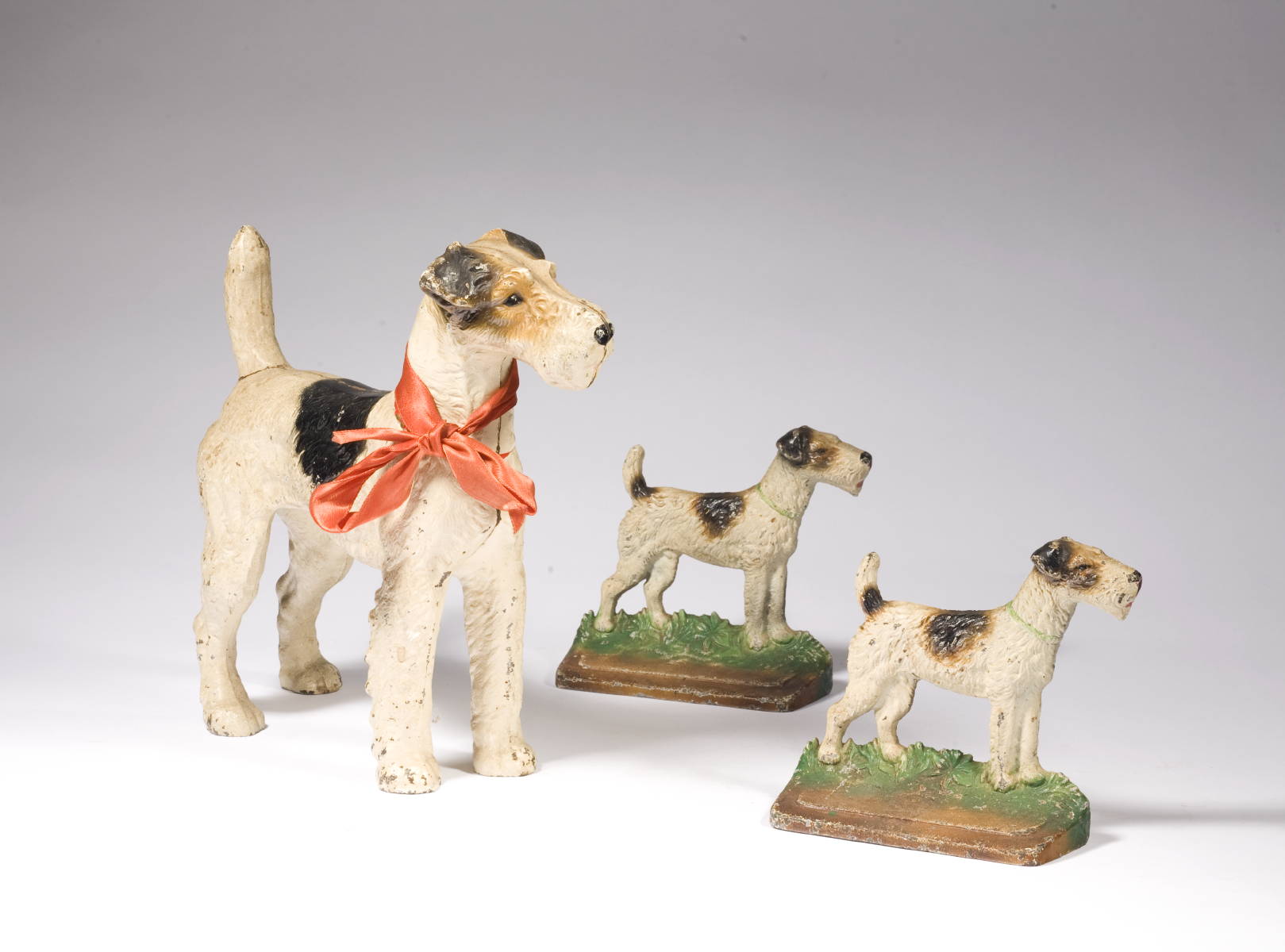 Appraisal: AMERICAN POLYCHROME PAINTED CAST IRON TERRIER-FORM DOOR STOP AND A