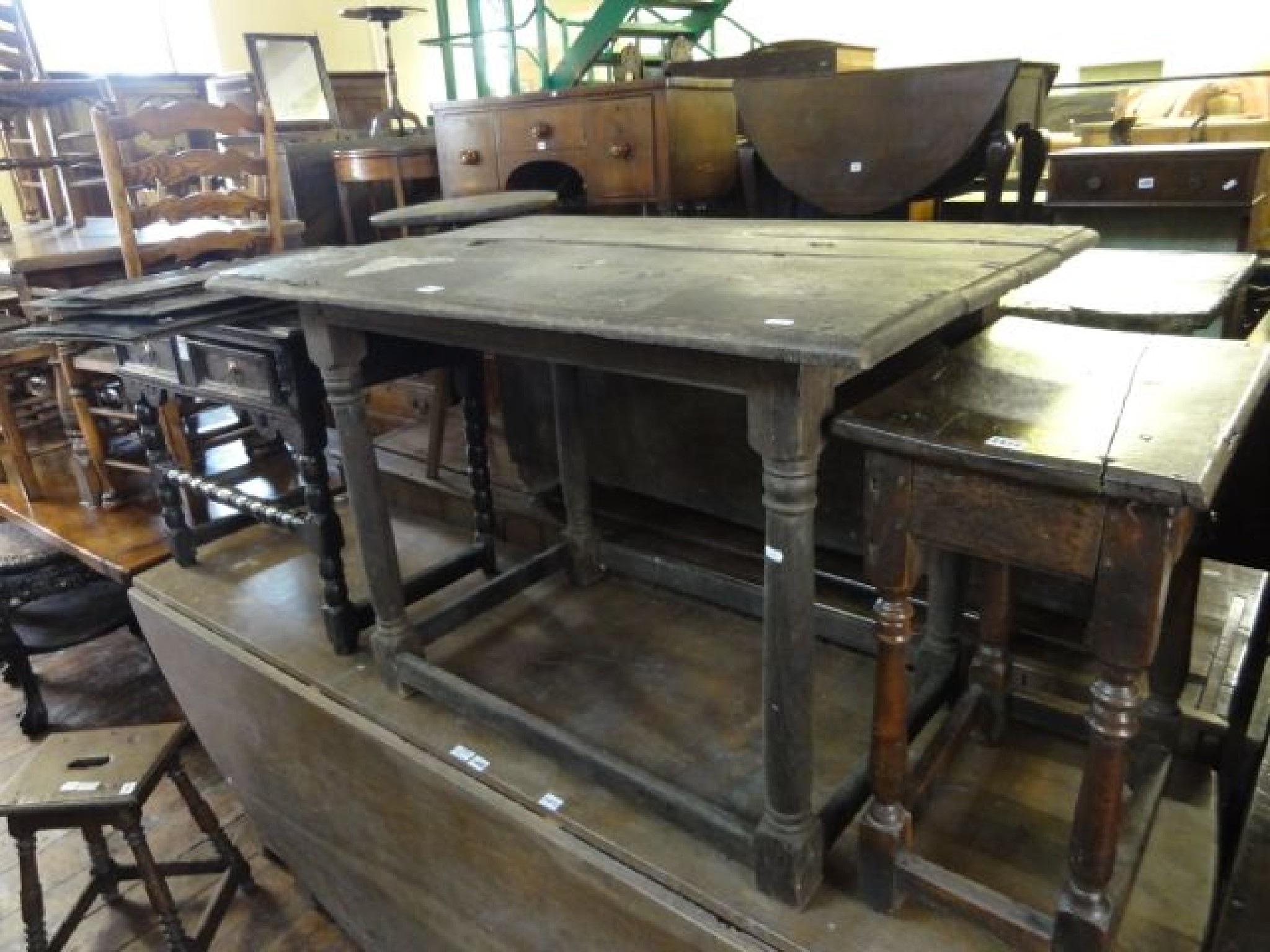 Appraisal: An old English oak centre table the plank top raised