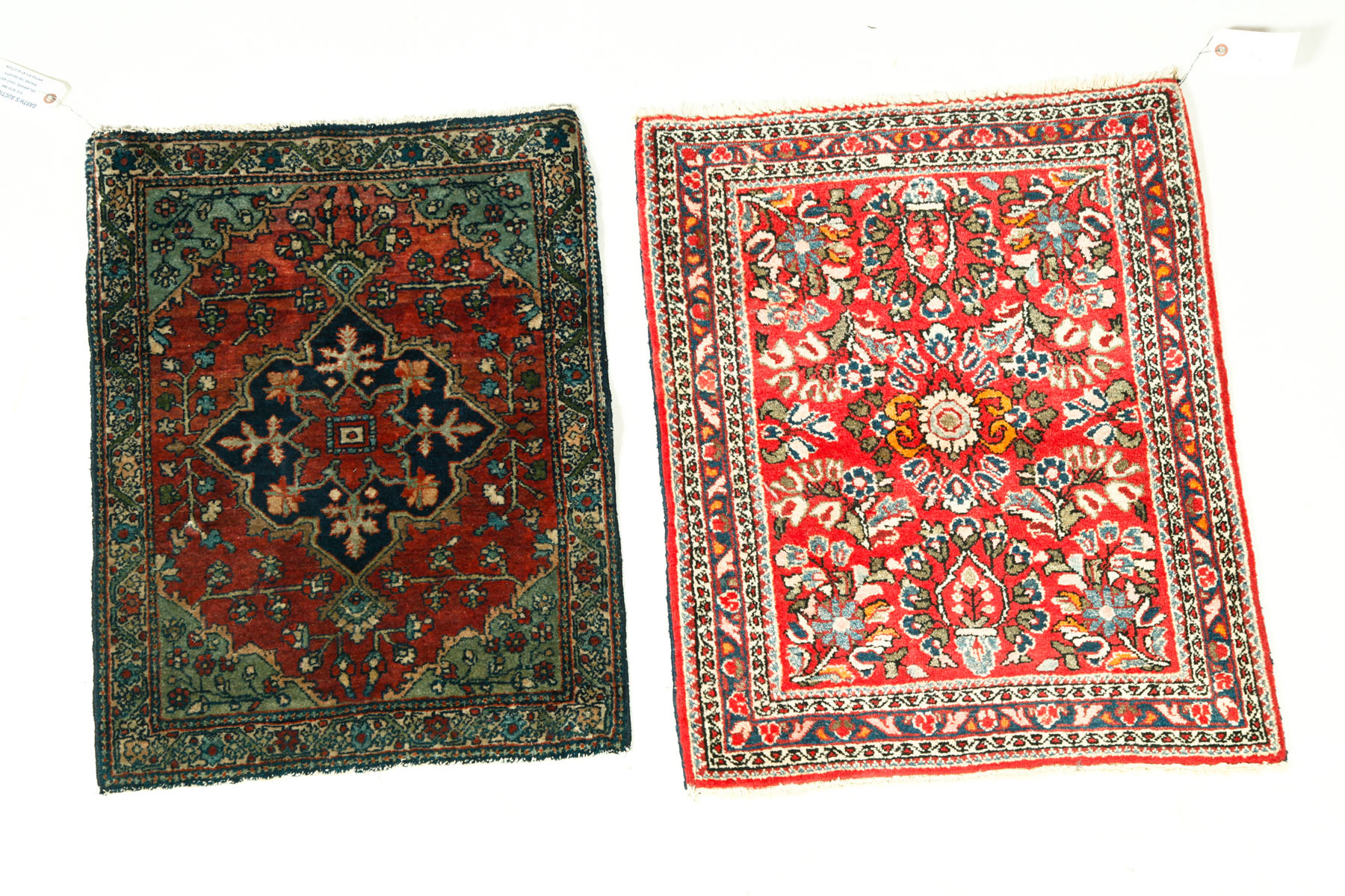 Appraisal: TWO ORIENTAL MATS Twentieth century Sarouks Red ground and blue