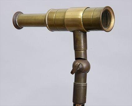 Appraisal: SPY GLASS-HANDLED EBONIZED WOOD WALKING STICK The brass ringed handle