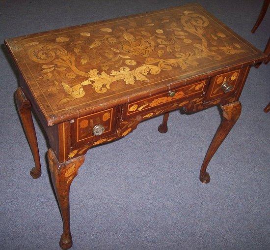 Appraisal: An th Century Dutch walnut marquetry kneehole table the top