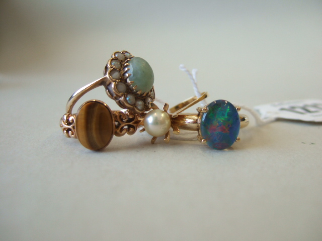 Appraisal: A gold ring claw set with an oval opal doublet