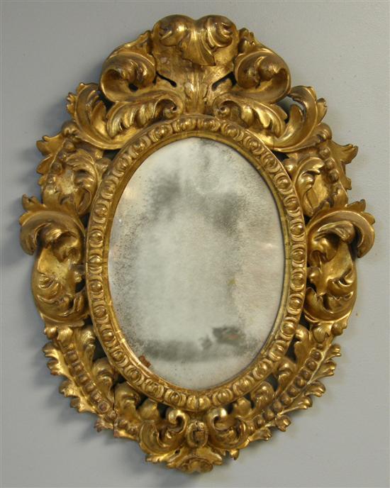 Appraisal: Carved wood and gilt gesso oval mirror with scrolled and