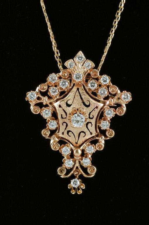 Appraisal: Shield and scroll design diamond brooch pendant in marked K