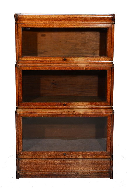 Appraisal: A GLOBE WERNICKE STYLE THREE SECTIONAL OAK BOOKCASE with glazed