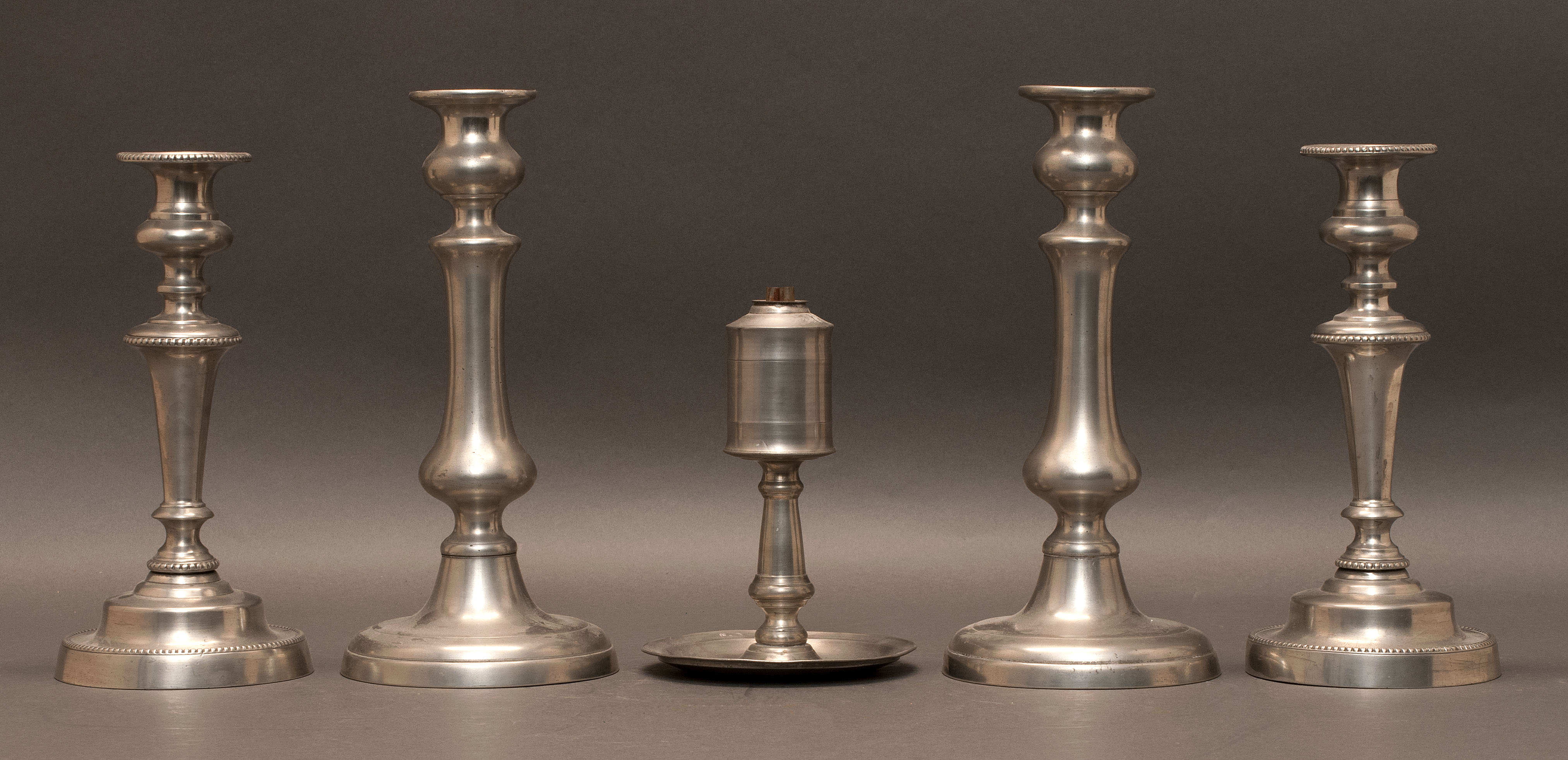 Appraisal: TWO PAIRS OF PEWTER CANDLESTICKS th CenturyTogether with a saucer-base