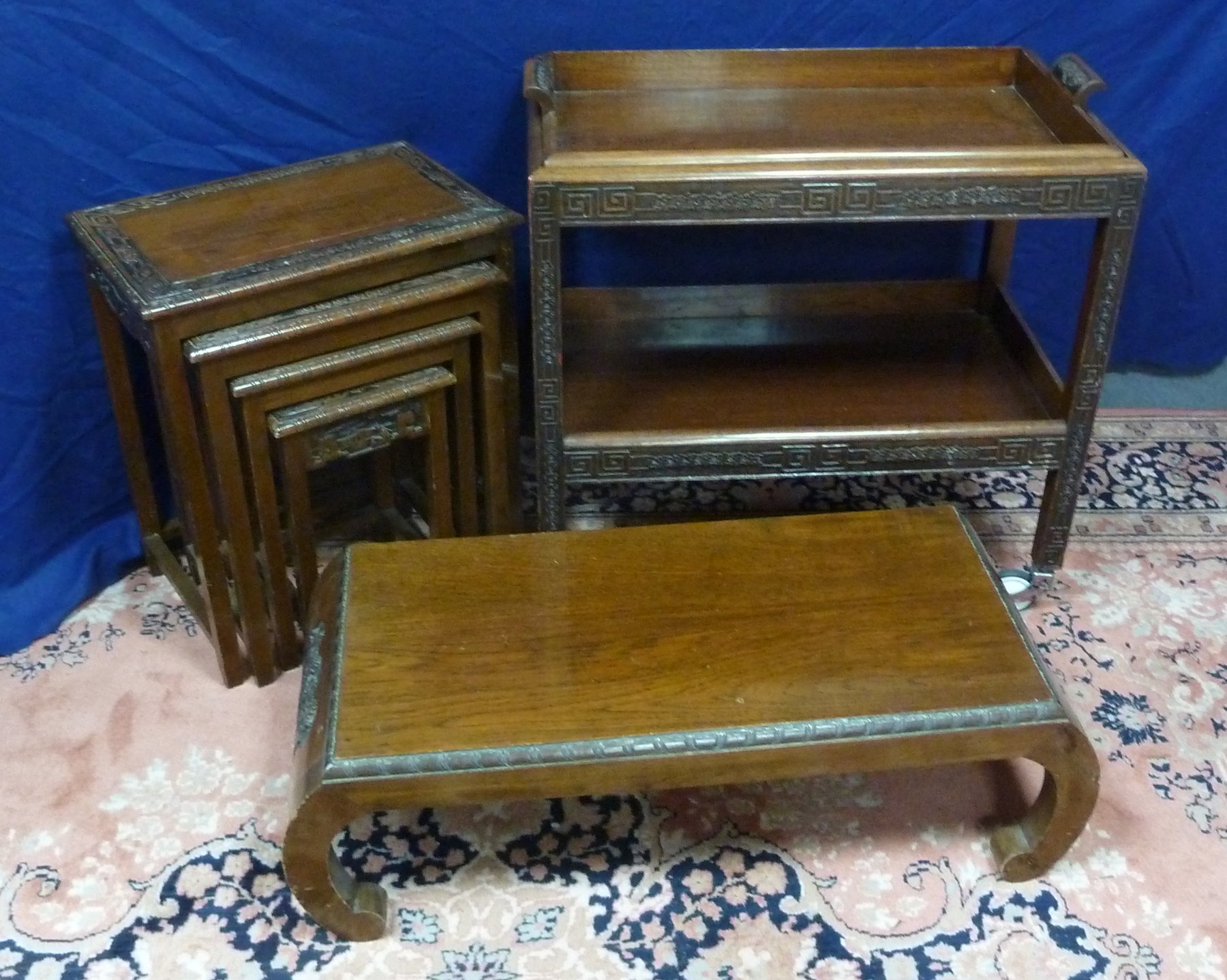 Appraisal: A nest of four Malayan hardwood tables with carved borders