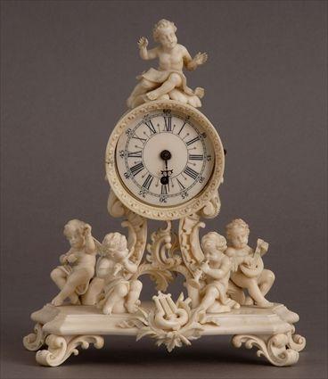 Appraisal: CONTINETAL ROCOCO-STYLE CARVED IVORY MINIATURE CLOCK The in dial within