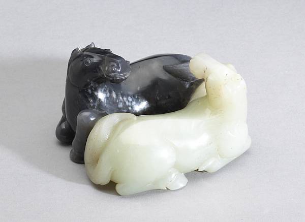 Appraisal: A striated jade horse group Depicting two recumbent facing horses