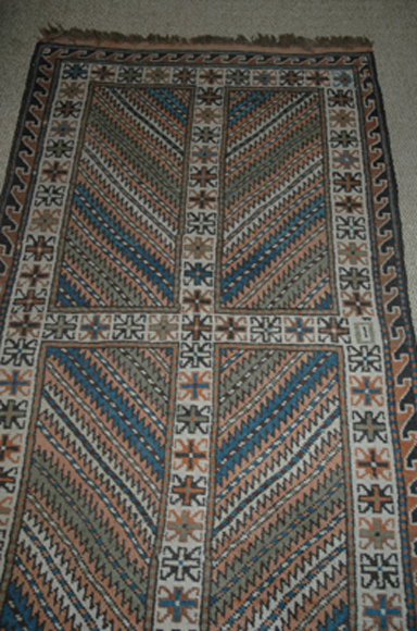 Appraisal: A CAUCASIAN KUBA RUG Woven with stylised foliate panels in