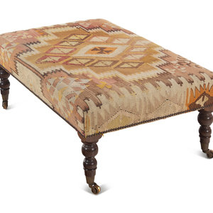 Appraisal: A Kilim Upholstered Ottoman th Century raised on turned mahogany