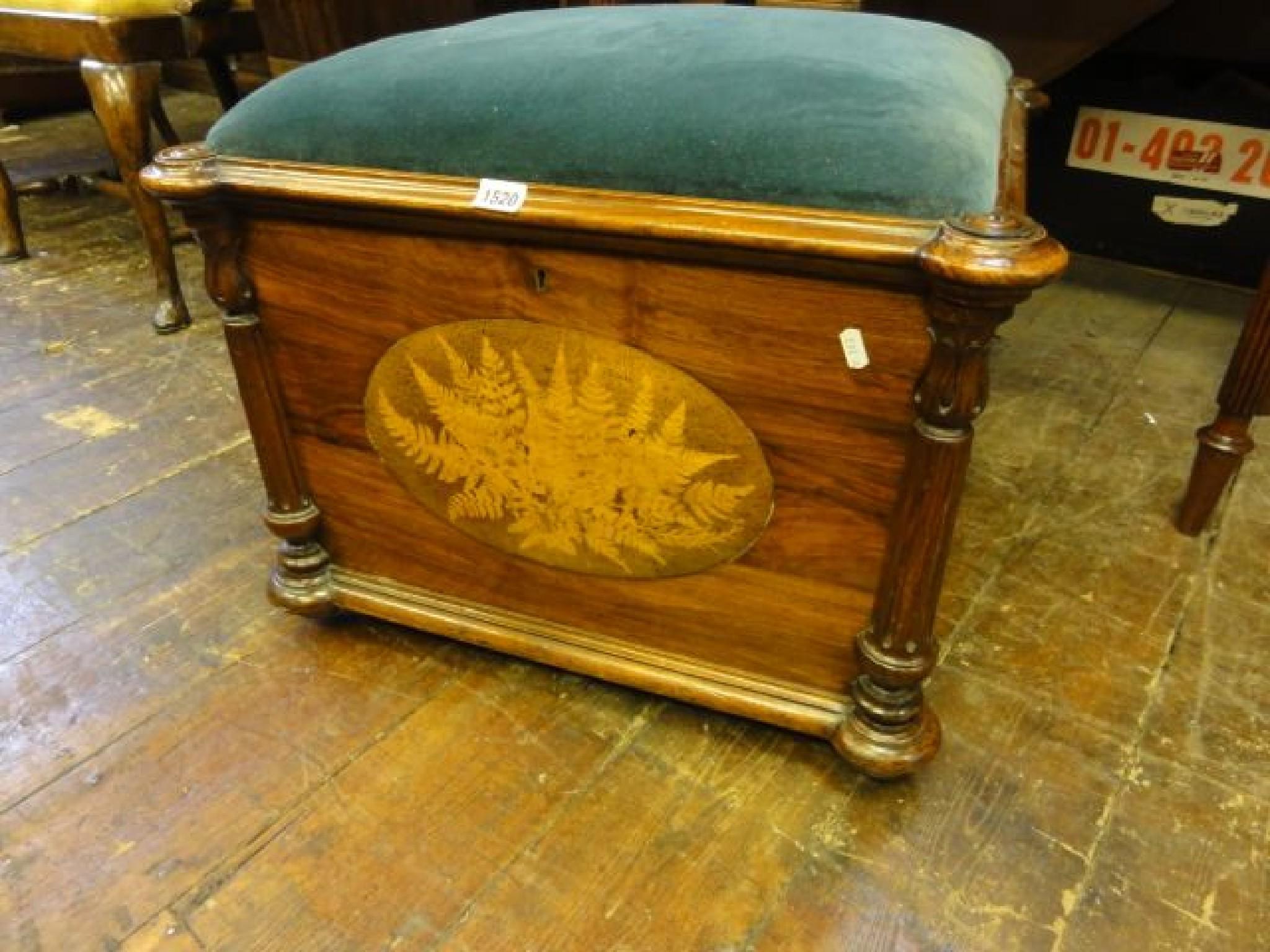 Appraisal: A Victorian walnut box seat with upholstered lid raised on