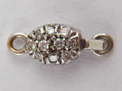 Appraisal: A white metal tests carat gold diamond clasp for a