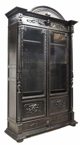 Appraisal: Spanish Renaissance Revival ebonized bookcase th c demi-lune crest over