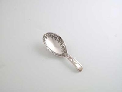 Appraisal: A George III caddy spoon with a repeating border of