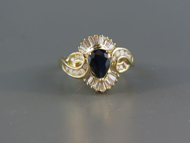 Appraisal: Sapphire and Diamond Ring deep blue pear shape sapphire weighing