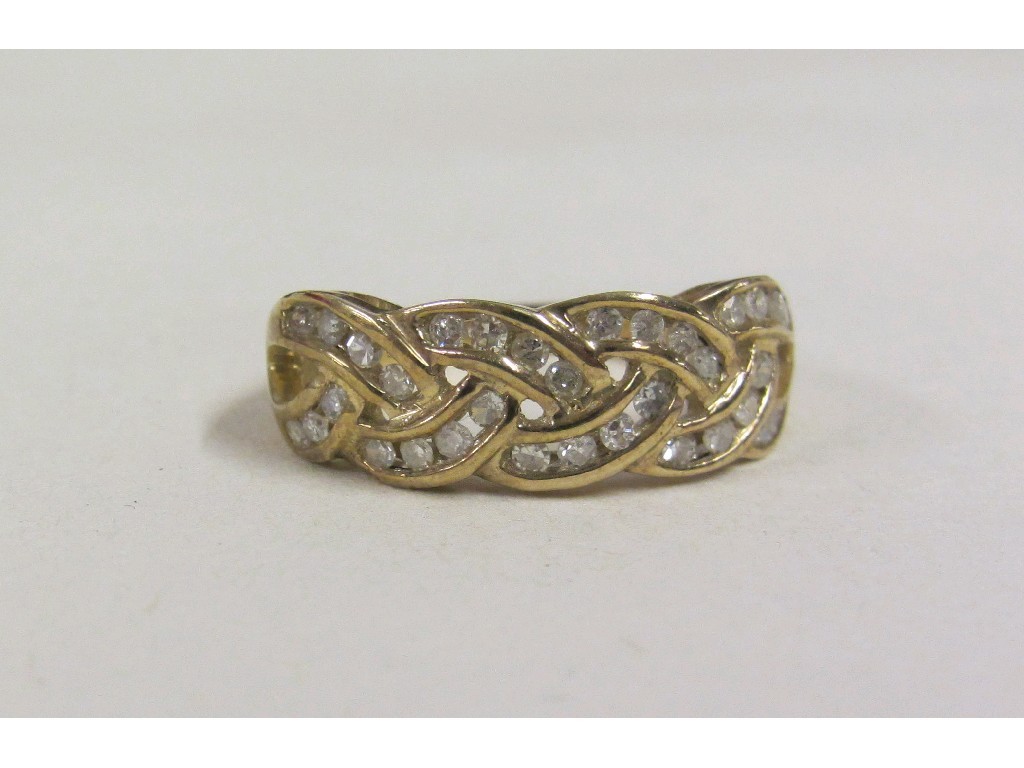 Appraisal: Nine carat gold channel set diamond set knotwork ring with