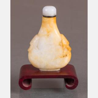 Appraisal: A Carved Jade Snuff Bottle with White Jade Stopper on