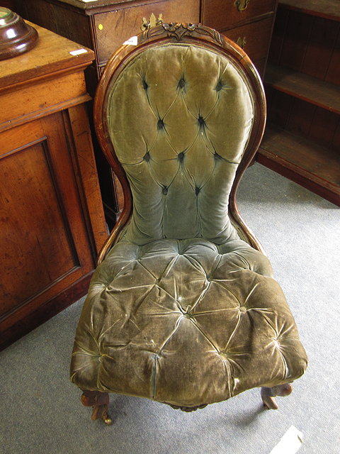 Appraisal: A VICTORIAN WALNUT FRAMED NURSING CHAIR with blue velvet button