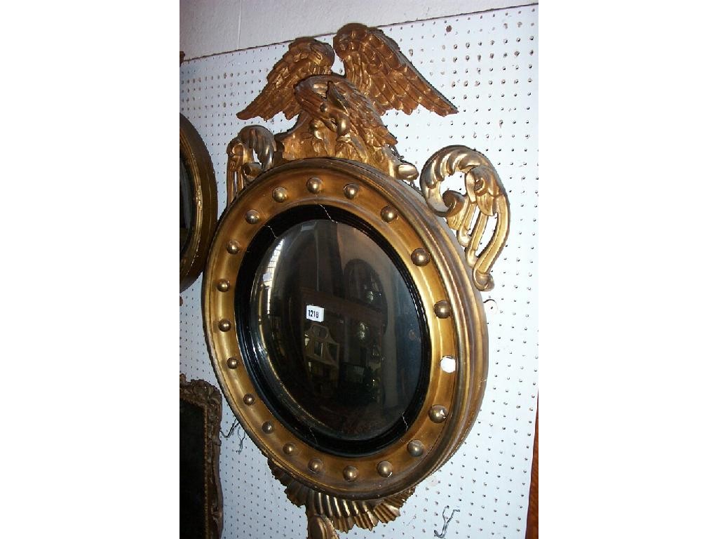 Appraisal: A Regency convex wall mirror or usual form with ebonised