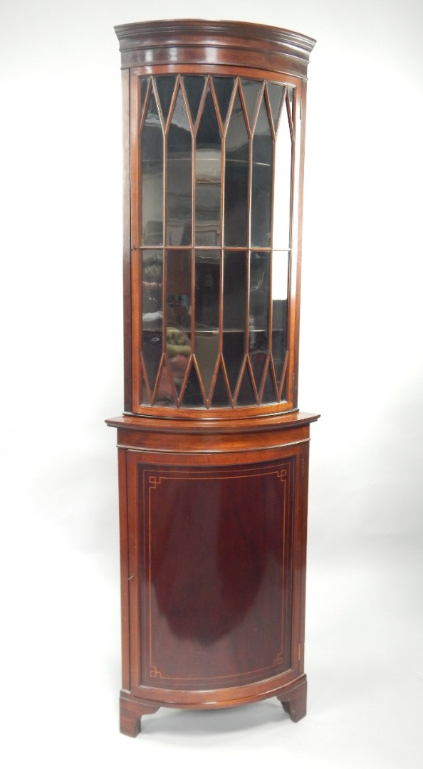 Appraisal: A Victorian mahogany bowfronted corner display cabinet having astragal glazed