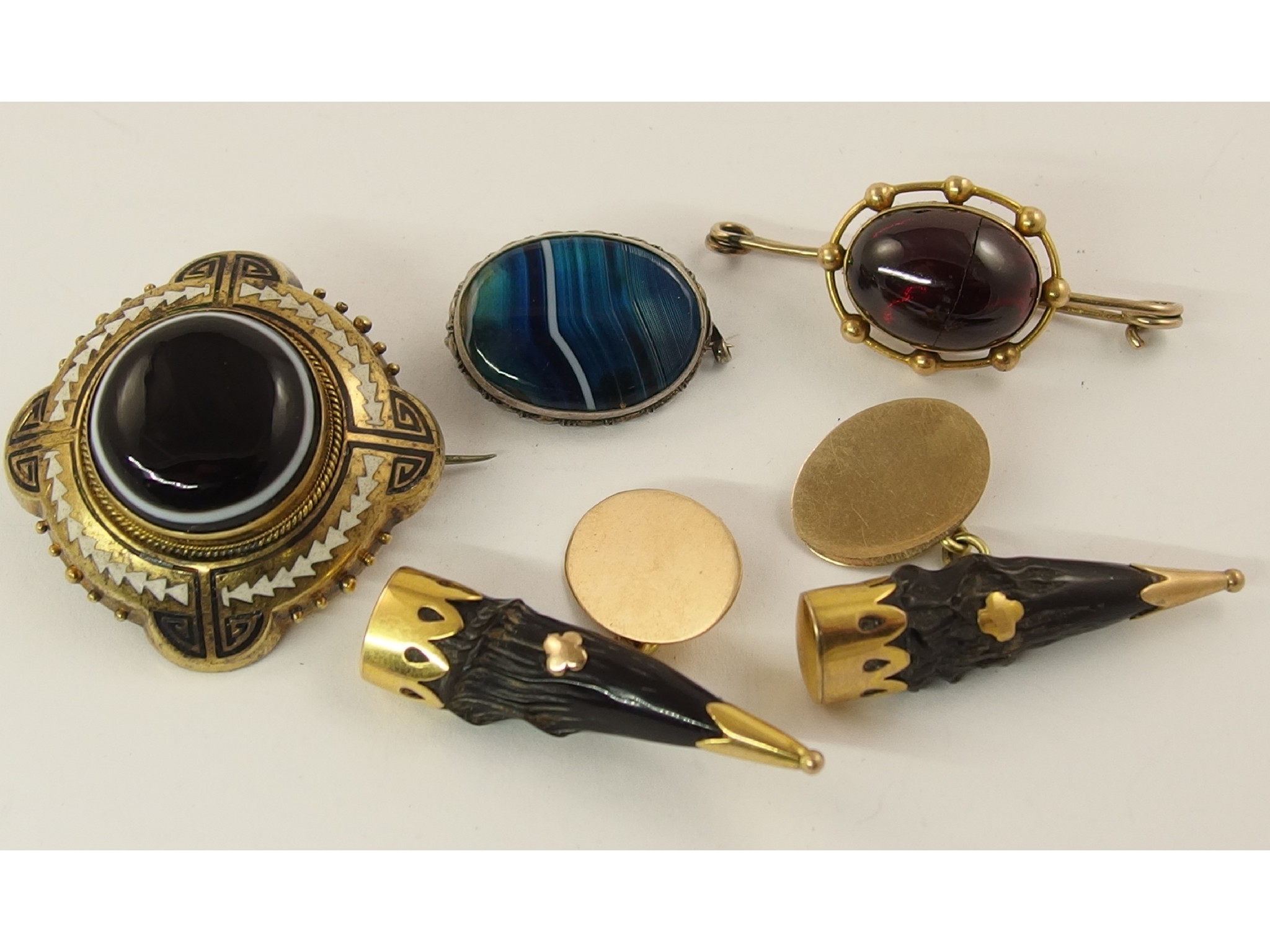 Appraisal: A pair of yellow metal mounted gazelle horn cufflinks a