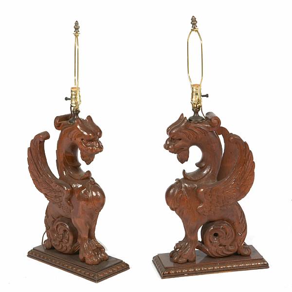 Appraisal: A pair of carved hardwood griffin form table lamps height