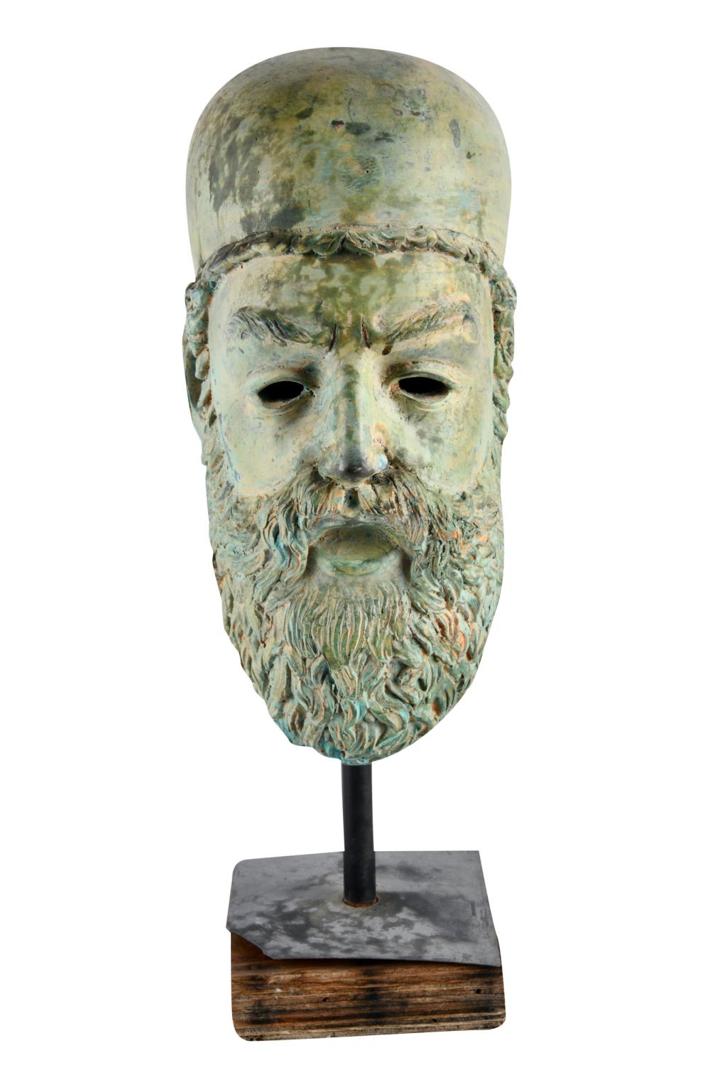 Appraisal: BRONZE HEAD OF A MANwith green patina on a wood