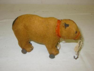 Appraisal: A pre-war bear on wheels the brown felt covering with