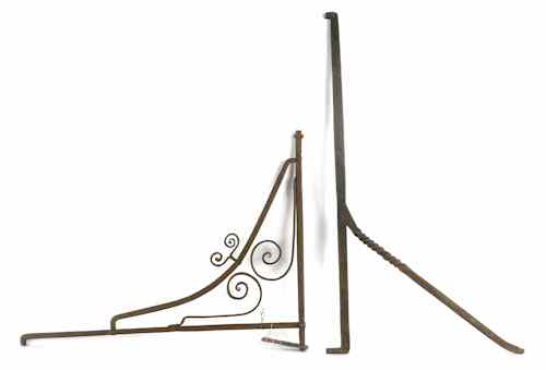 Appraisal: Two wrought iron fireplace cranes th c l and l