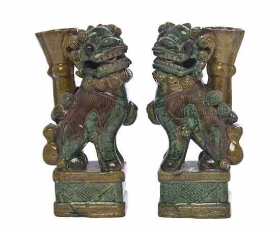 Appraisal: A Pair of Ceramic Sancai Fu Dog Vases depicted with