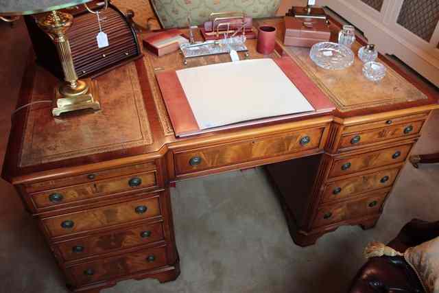 Appraisal: A MAHOGANY BREAKFRONT PEDESTAL DESK with triple leather inset top